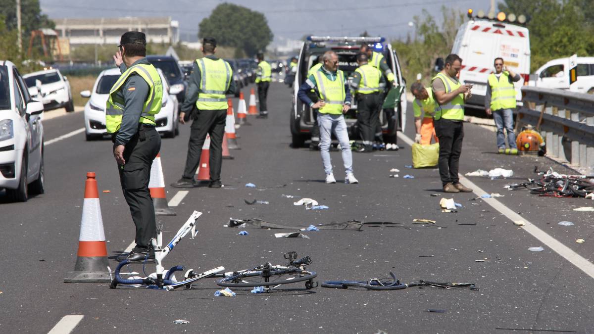 Agentes de la Guardia Civil y miembros de Emergencias en el punto kilométrico 205 de la N-332 entre las localidades de Oliva y Denia, donde la conductora de un turismo ,que ha dado positivo en el control de alcohol y drogas , ha arrollado a un grupo de seis ciclistas de un equipo de Jàvea, provocando la muerte de dos de ellos y heridas graves a otros tres.