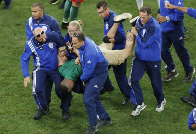 Pitch invader Shamshir Karimi carried from the field of play after he tried to hug Cristiano Ronaldo during Euro 2016.