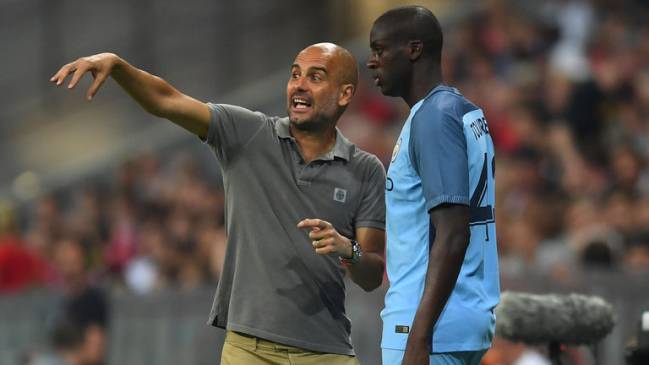 Pep Guardiola issuing instruction to Yaya Toure