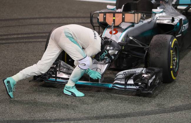 Nico Rosberg of Germany and Mercedes GP embraces his car after finishing second and securing the F1 World Drivers Championship