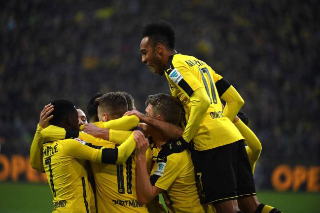 Dortmund's players celebrate during the German first division Bundesliga football match between Borussia Dortmund and Borussia Moenchengladbach