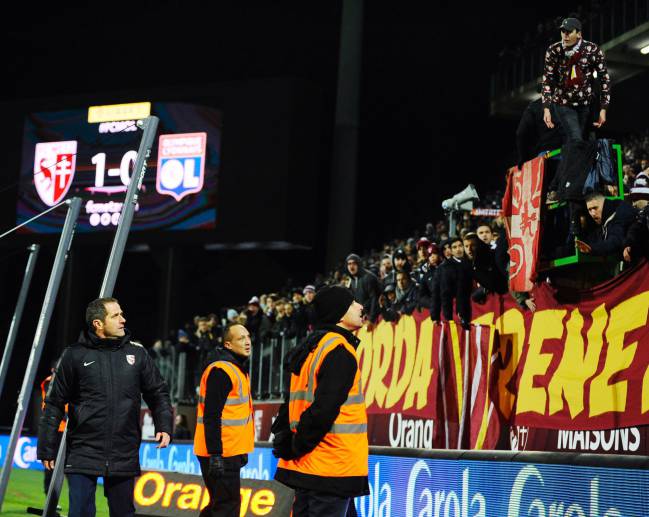 Metz' French head coach Philippe Hinscherberger argues with Metz' supporters after a firecracker exploded on the pitch.