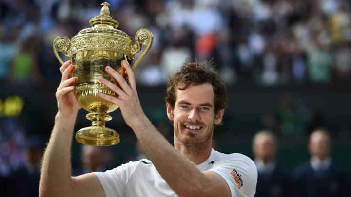 Britain's Andy Murray posing with the winner's trophy after his men's singles final victory over Canada's Milos Raonic on the last day of the 2016 Wimbledon Championships