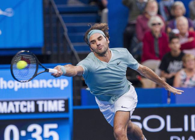 Federer reaches for a shot during his match against Gasquet