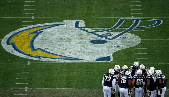 The offense of the San Diego Chargers in huddle against the Kansas City Chiefs