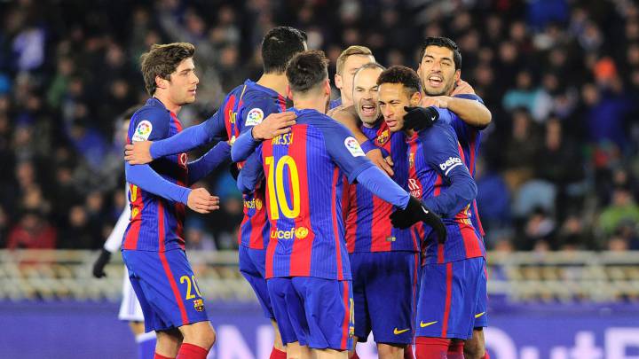 Barcelona's players celebrate after Brazilian forward Neymar scored his team's first goal during the Spanish Copa del Rey quarter final first leg football match Real Sociedad