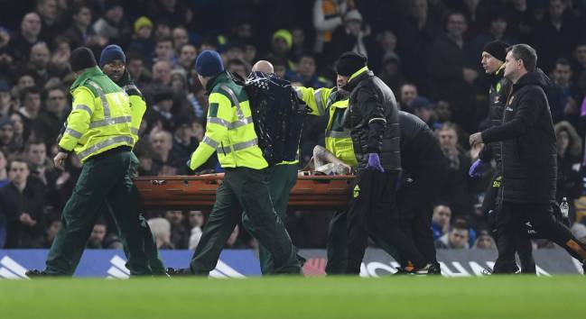 Hull City's Ryan Mason (C) is taken off the pitch by medical teams after a collision with Chelsea's Gary Cahill