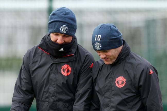 Wayne Rooney of Manchester United walks out with Bastian Schweinsteiger for a training session