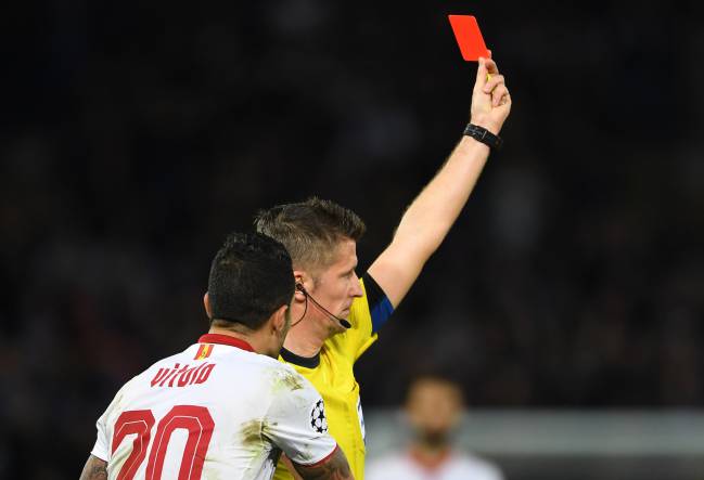 Vitolo of Sevilla remonstrates with referee Daniele Orsato of Italy as he shows the red card to Samir Nasri