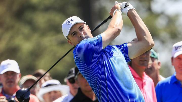 Jordan Spieth of the US hits a tee shot on the first hole of a practice round as the Drive, Chip & Putt Championship goes on elsewhere on the course at the 2017 Masters Tournament at the Augusta.