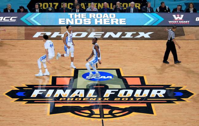 Justin Jackson Nate Britt and Theo Pinson of the North Carolina Tar Heels celebrate after defeating the Gonzaga Bulldogs.