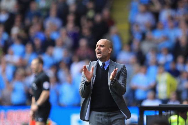 Guardiola, applauds his Manchester City players.