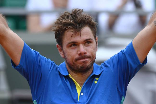 Switzerland's Stanislas Wawrinka celebrates after winning aaginst Slovakia's Jozef Kovalik