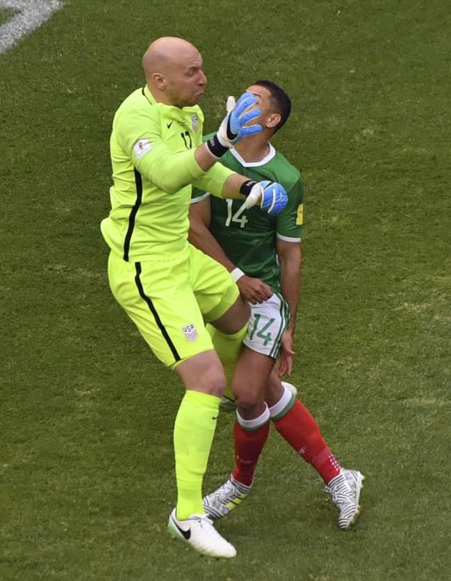 Mexico's Javier Hernandez vies with US's goalkeeper Brad Guzan.
