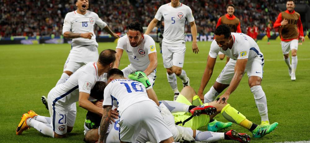 Chile’s Claudio Bravo celebrates with team mates after winning the penalty shootout