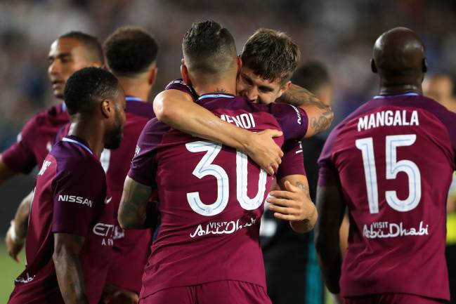 John Stones congratulates Nicolas Otamendi after Manchester City open scoring.
