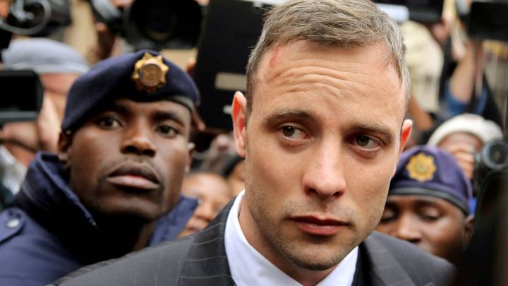Olympic and Paralympic track star Oscar Pistorius leaves court after appearing for the 2013 killing of his girlfriend Reeva Steenkamp