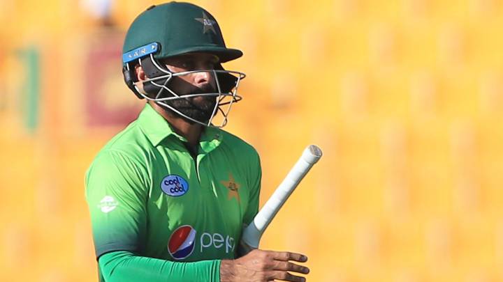 Pakistan's Muhammad Hafeez leaves the field after being dismissed by Sri Lank's Nickwella Dickwella