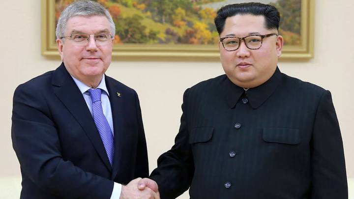 North Korean leader Kim Jong-Un (R) shaking hands with President of the International Olympic Committee Thomas Bach