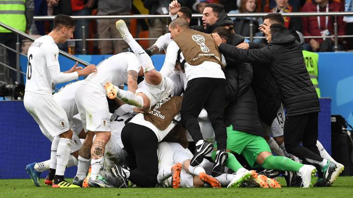 Uruguay players celebrate after Uruguay's defender Jose Gimenez scored the opening goal