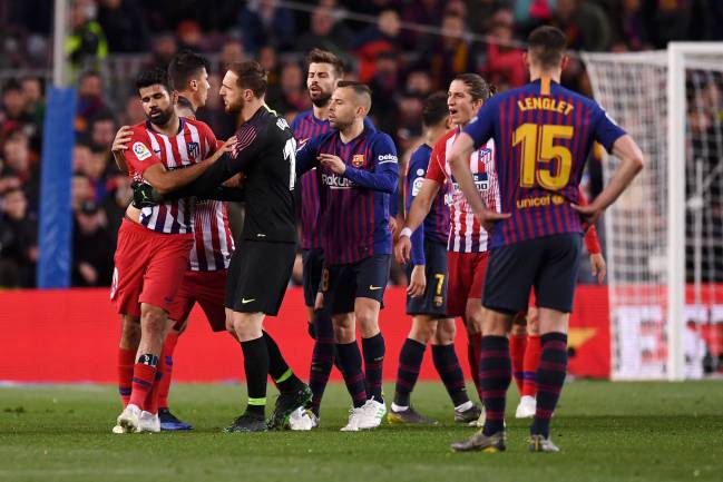 Fool | Diego Costa of Atletico Madridis restrained by team mate Jan Oblak