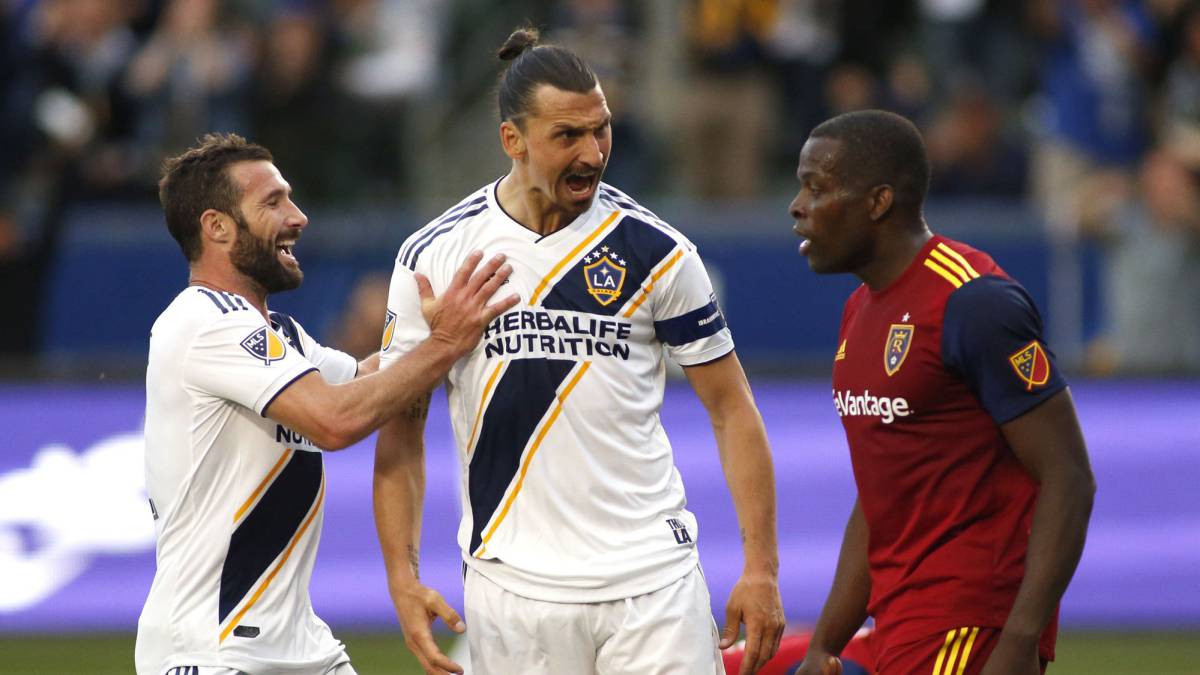 Chris Pontius and Zlatan Ibrahimovic of Los Angeles Galaxy celebrate Ibrahimovic's goal as he yells at Nedum Onuoha of Real Salt Lake
