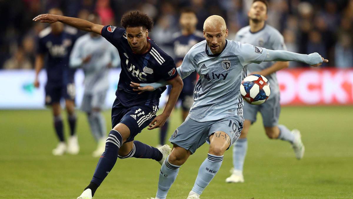 Yohan Croizet of Sporting Kansas City and Tajon Buchanan of New England Revolution compete for the ball