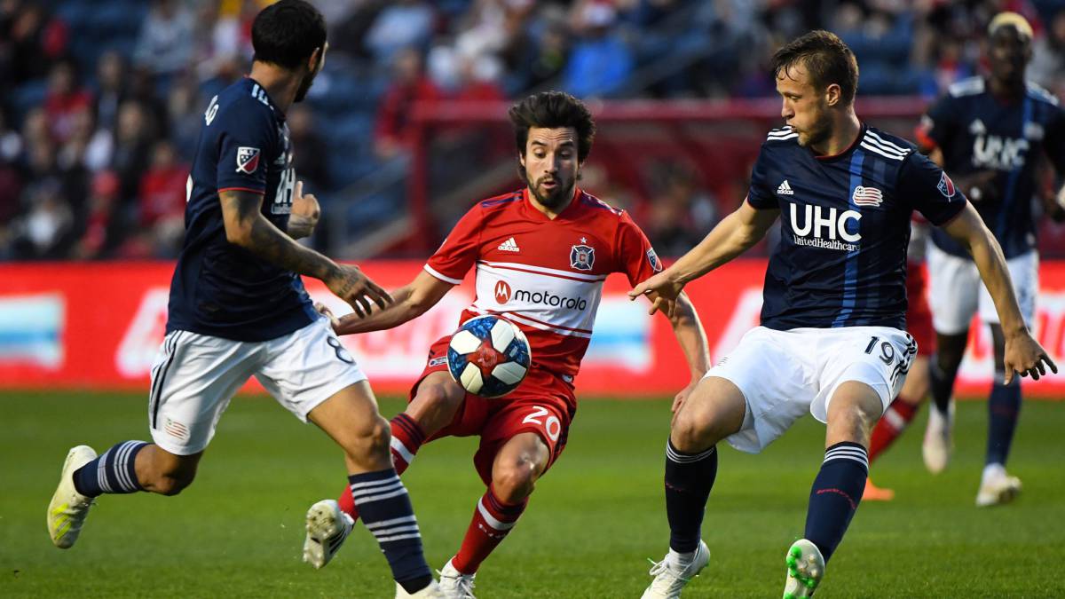 Chicago Fire midfielder Nicolas Gaitan kicks the ball past New England Revolution defender Antonio Delamea Mlinar