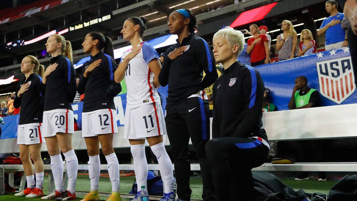 Megan Rapinoe protests against Donald Trump administration by kneeling during the national anthem