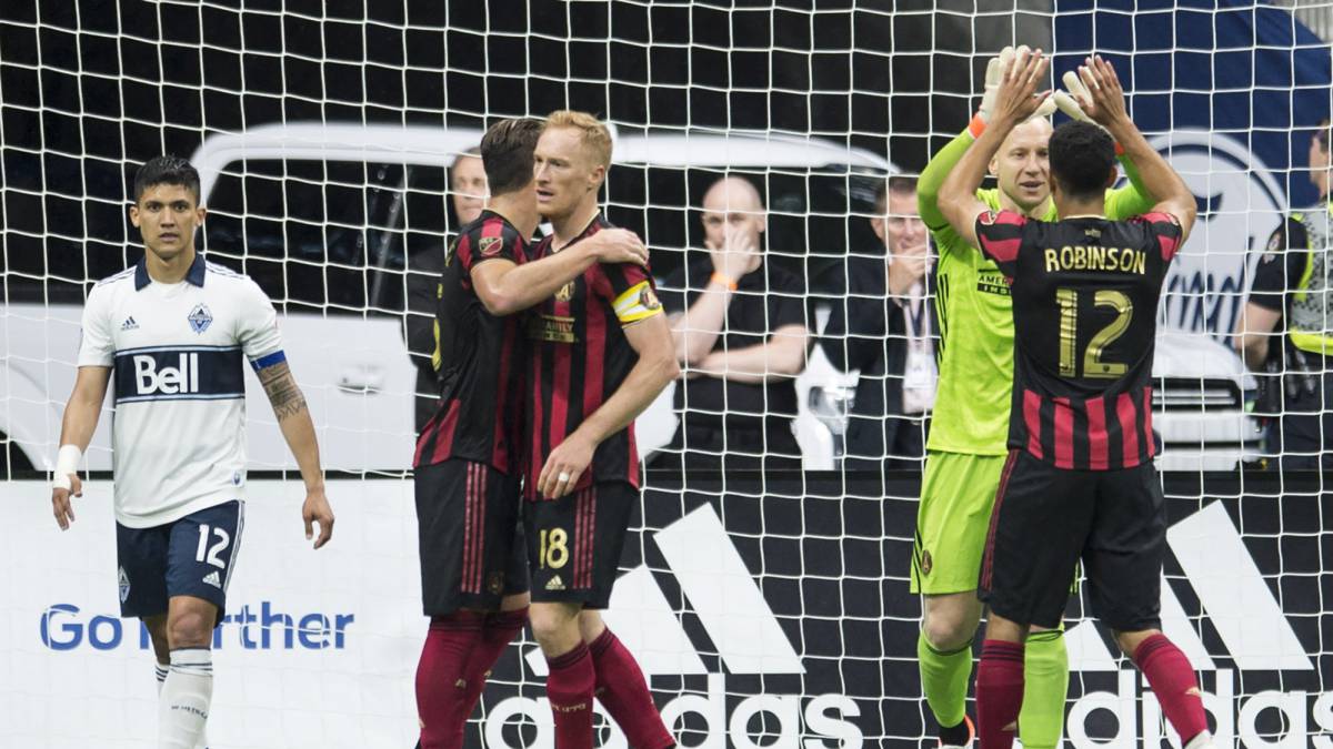 Atlanta United players celebrate a 1-0 win over the Vancouver Whitecaps during an MLS soccer match