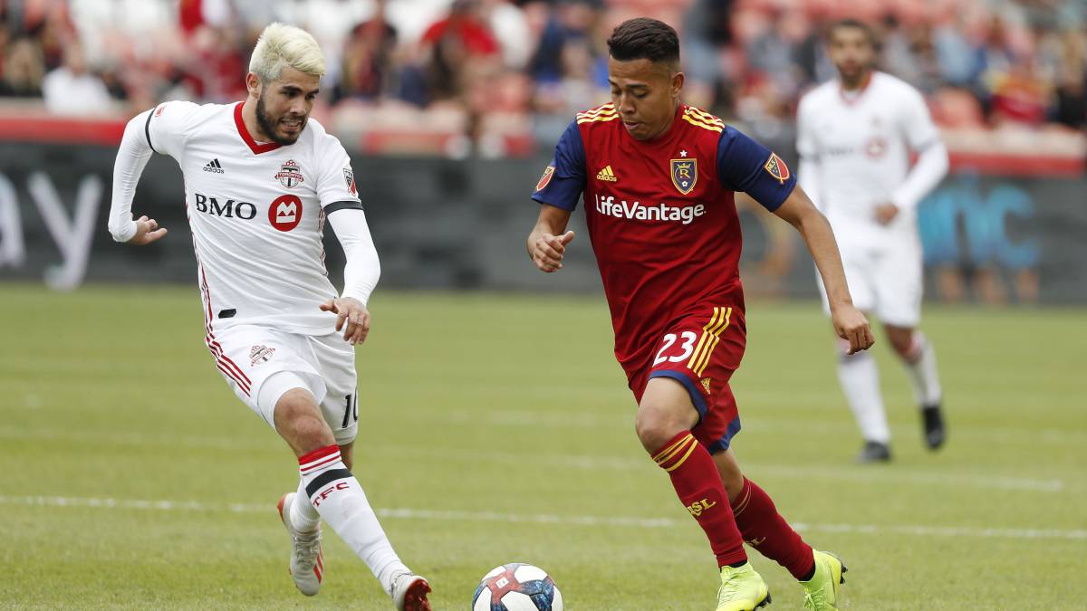 Toronto FC midfielder Alejandro Pozuelo and Real Salt Lake midfielder Sebastian Saucedo battle in the second half at Rio Tinto Stadium in Sandy, Utah