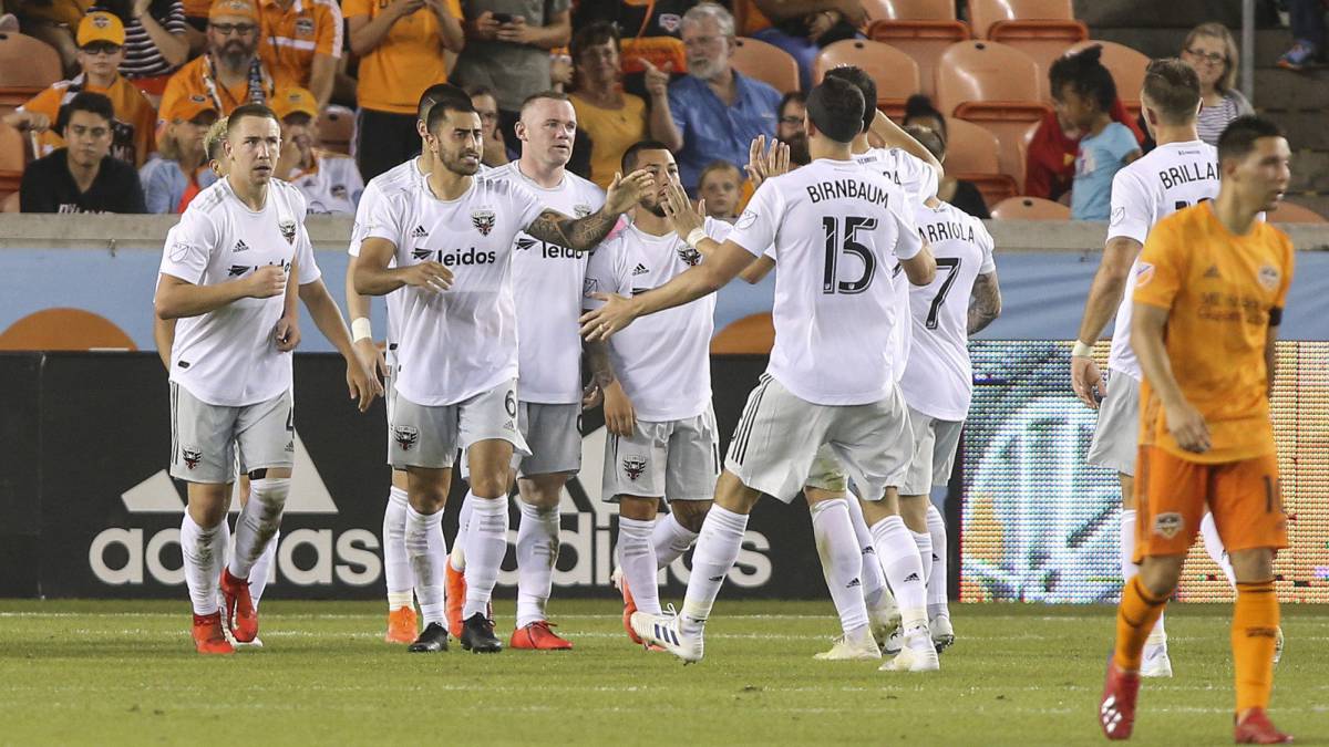 D.C. United forward Wayne Rooney celebrates with teammates after scoring a goal during the second half against the Houston Dynamo