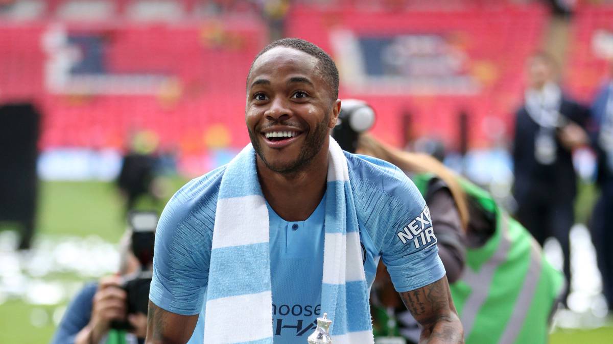 Raheem Sterling of Manchester City celebrates with the trophy after victory in the FA Cup Final match between Manchester City and Watford at Wembley Stadium