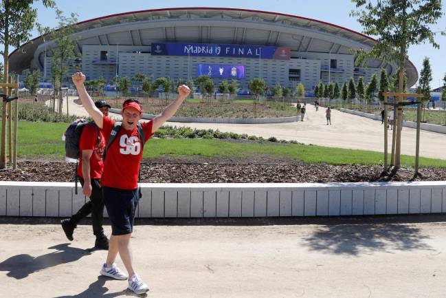 Liverpool fans take an early walk around the Metropolitano Stadium.