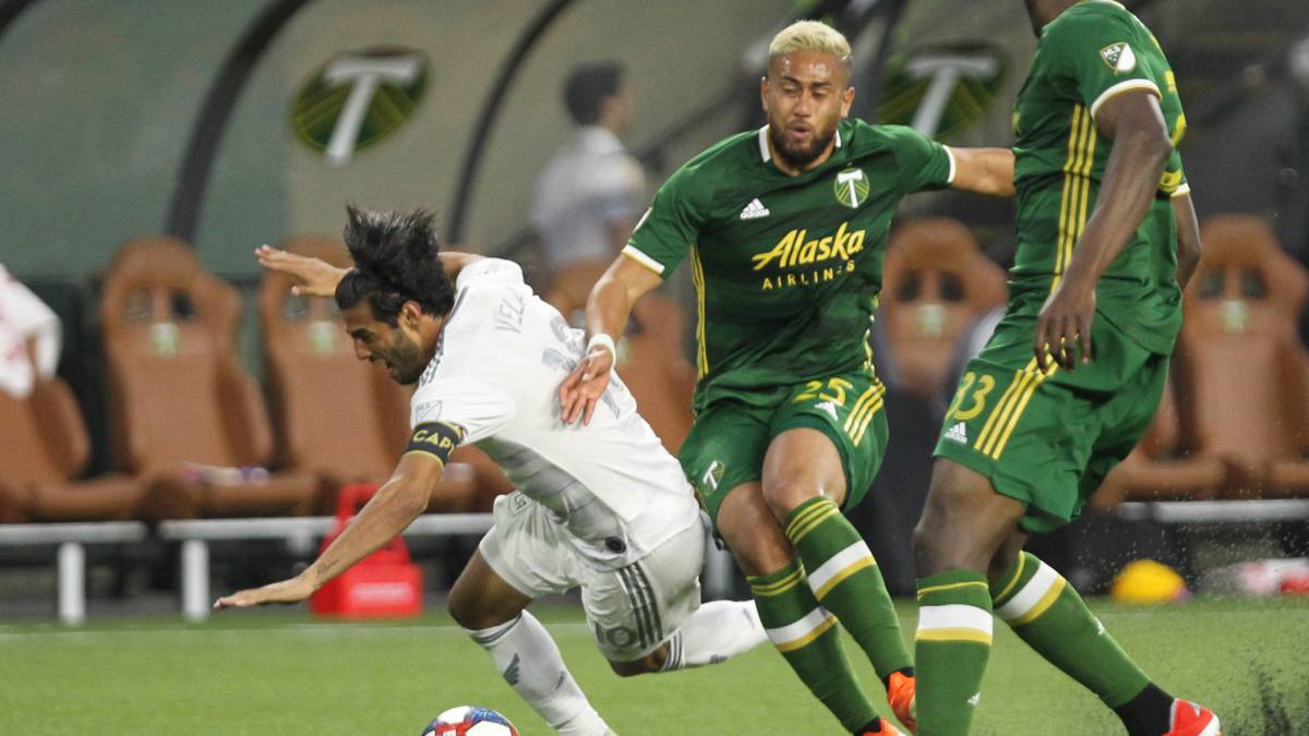 Los Angeles FC forward Carlos Vela and Portland Timbers defender Bill Tuiloma collide in the second half at Providence Park. Mandatory