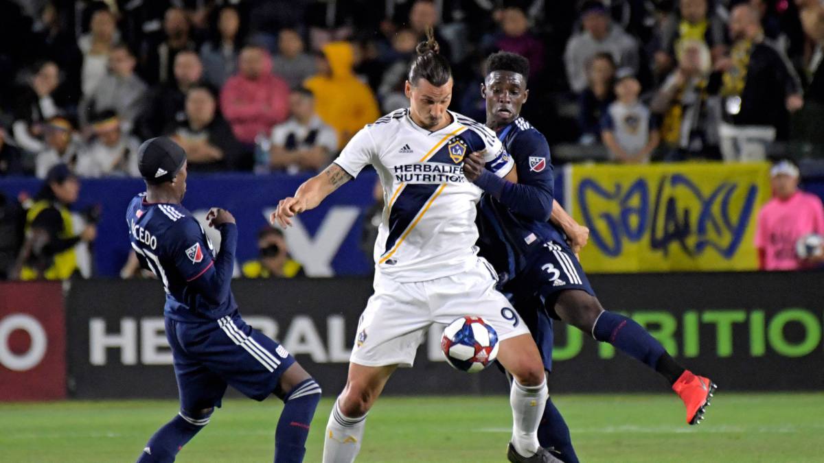 LA Galaxy forward Zlatan Ibrahimovic controls the ball in front of New England Revolution defender Jalil Anibaba in the first half at StubHub Center.