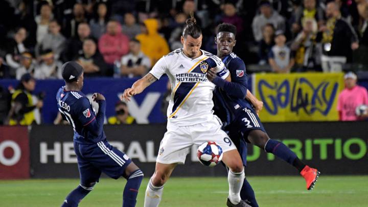 LA Galaxy forward Zlatan Ibrahimovic controls the ball in front of New England Revolution defender Jalil Anibaba in the first half at StubHub Center.