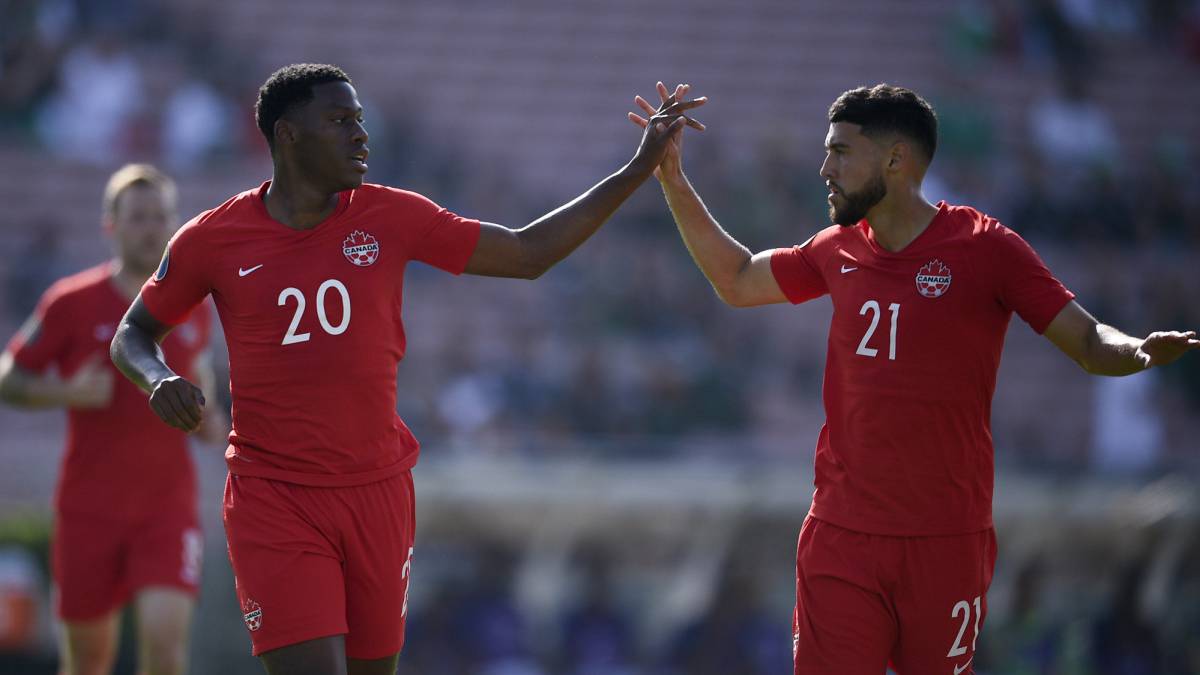 Canada forward Jonathan David celebrates with midfielder Jonathan Osorio after scoring a goal during the first half of group play in the CONCACAF Gold Cup