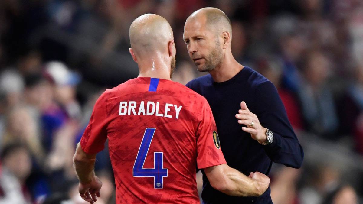 Head coach Gregg Berhalter of the United States welcomes Michael Bradley back to the bench after a substitution during the second half of the CONCACAF Gold Cup match against the Guyana