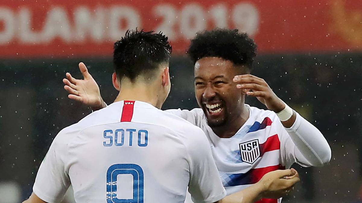 Chris Gloster celerating with Sebastian Soto after a United States win