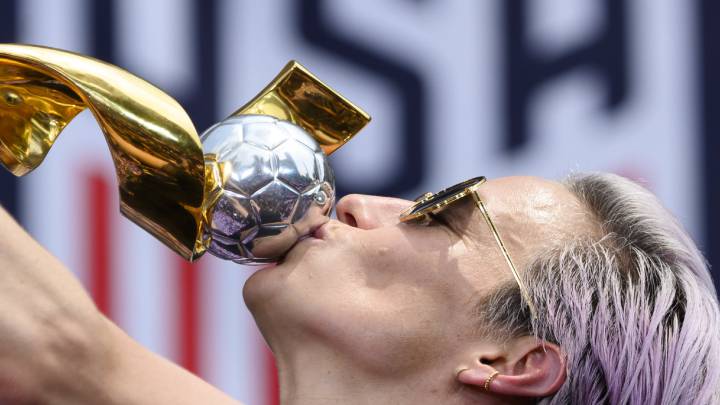 USA women's soccer player Megan Rapinoe kisses the trophy in front of the City Hall after the ticker tape parade for the women's World Cup champions
