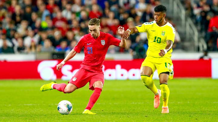 Tyler Boyd vies for the ball with Guyana's forward Emery Welshman during the 2019 CONCACAF Gold Cup Group D match between USA and Guyana