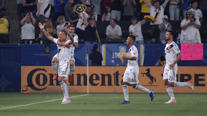 LA Galaxy defender Rolf Feltscher celebrates with midfielder Jonathan dos Santos and midfielder Efrain Alvarez and defender Giancarlo Gonzalez after scoring a goal in the first half at Dignity Health Sports Park