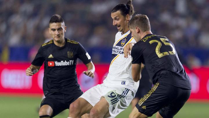 Zlatan Ibrahimovic handles the ball defended by Los Angeles FC defender Walker Zimmerman during the second half at StubHub Center