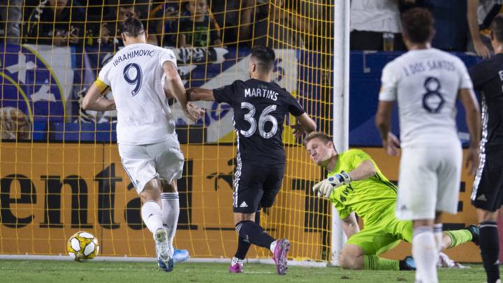 Zlatan Ibrahimovic scores on his deflected penalty shot by Sporting Kansas City goalkeeper Tim Melia during the first half at StubHub Center.