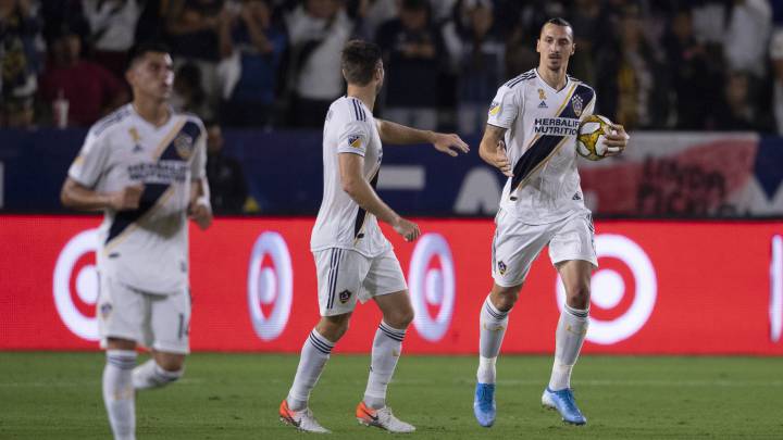 LA Galaxy forward Zlatan Ibrahimovic (9) celebrates his goal with defender David Romney (4) during the first half against Sporting Kansas Cityat StubHub Center