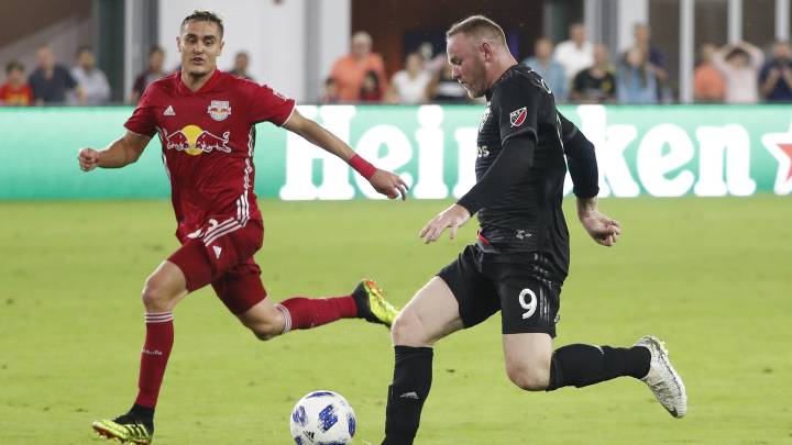 D.C. United forward Wayne Rooney (9) dribbles the ball as New York Red Bulls midfielder Aaron Long (33) defends in the second half at Audi Field. Red Bulls won 1-0