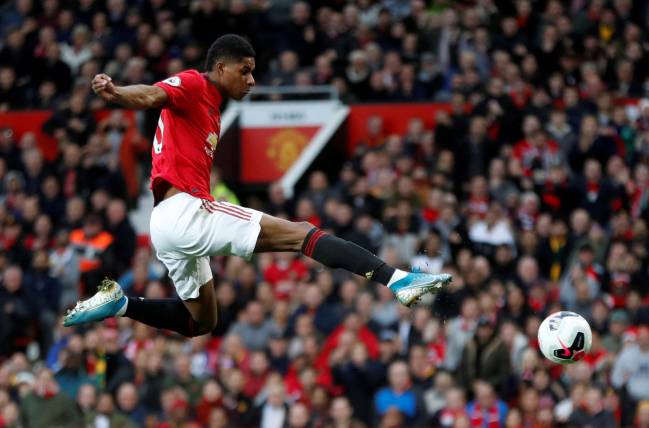 Manchester United's Marcus Rashford scores the opener against Liverpool.