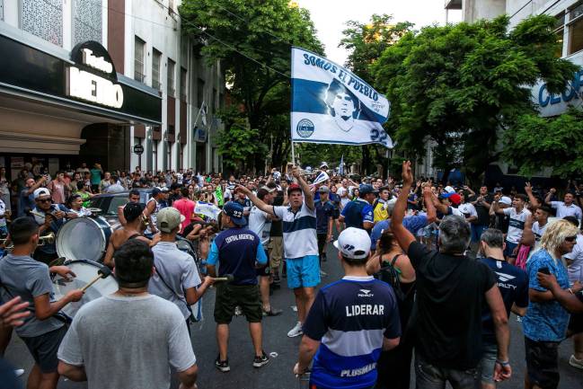Fans of Gimnasia y Esgrima La Plata congregate in support of Diego Maradona.