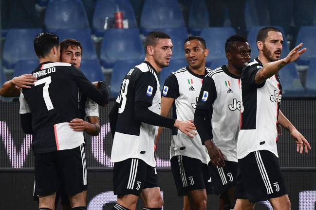 Juventus forward Paulo Dybala celebrates with Cristiano Ronaldo and teammates.